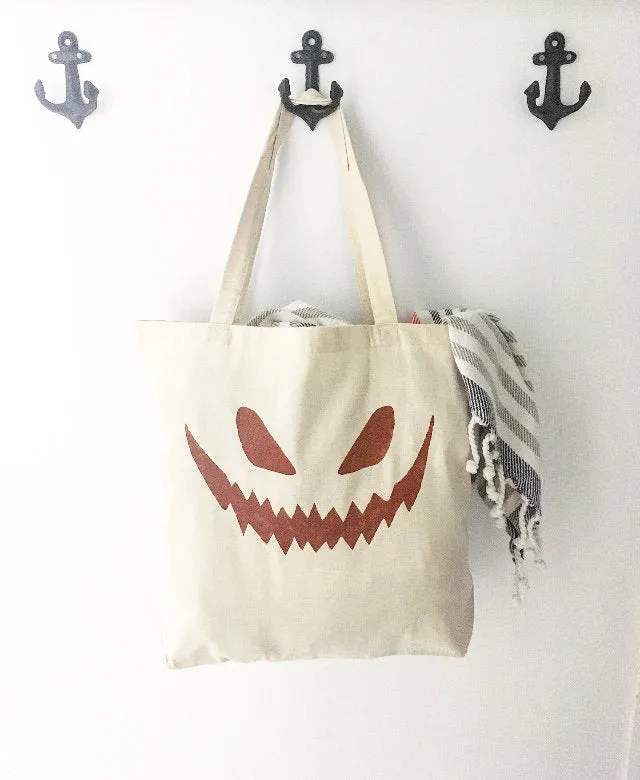 Jack-o-lantern face over sized canvas tote